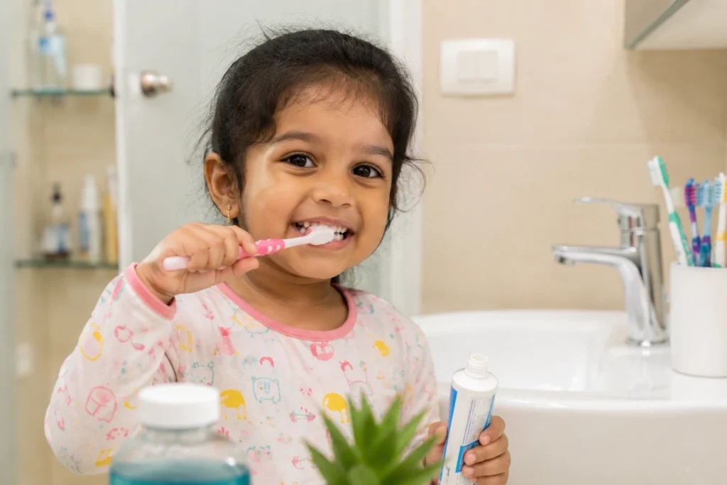Toddler smiling during a dental checkup at a pediatric dental clinic